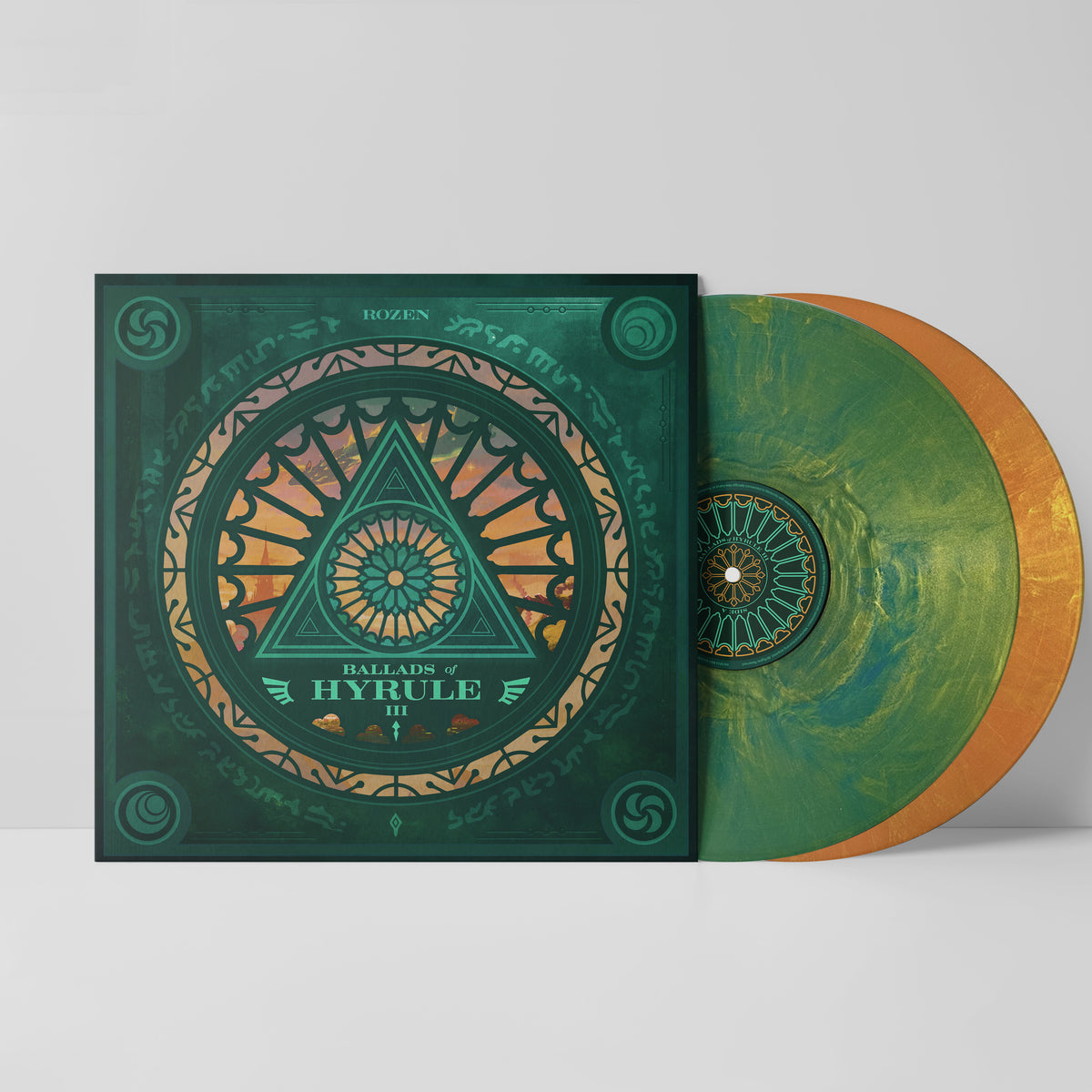 Ballads of Hyrule III vinyl featuring green and orange artwork reminiscent of a stained glass window with a triforce. The records are sticking out of the jacket, one green marble, one orangish gold.