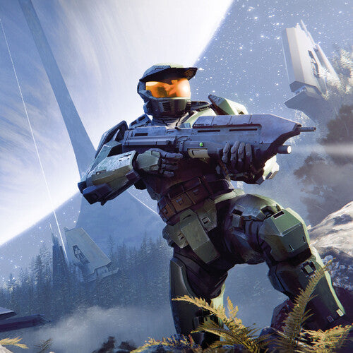 Master Chief holding a gun standing by a rock and fern with trees and a space scene in the background.