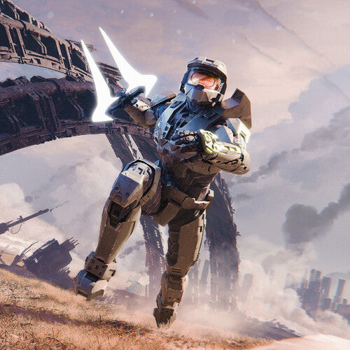 Master Chief sprinting while holding a plasma sword across a dry landscape and dilapidated metal structures are scattered behind him in the background
