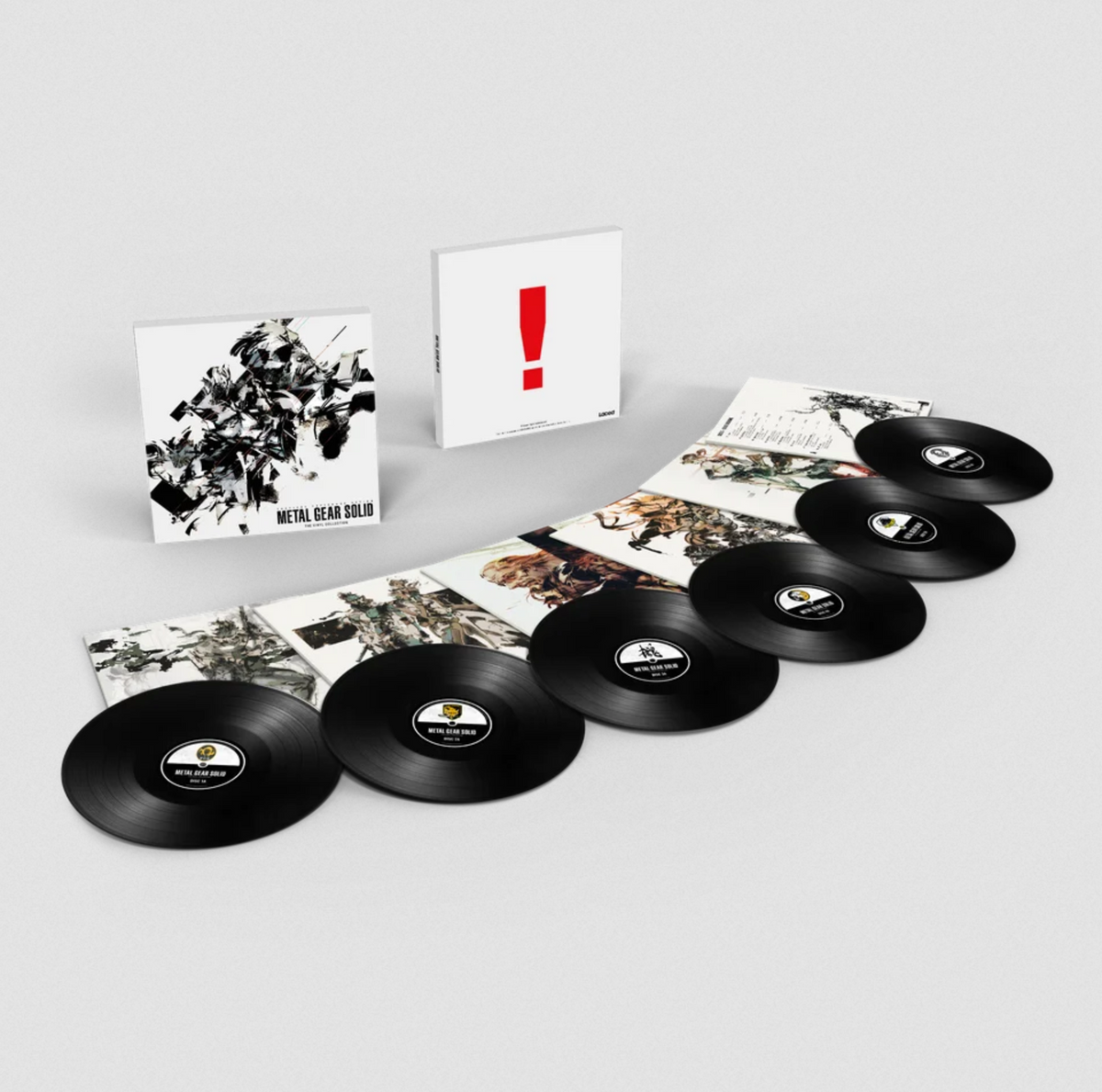Metal Gear Solid vinyl box set with the front and back of the box on display, one side having black and white illustrations and the other having a large red exclamation point, and then all the illustrative jackets spread out with the black records on top partially.