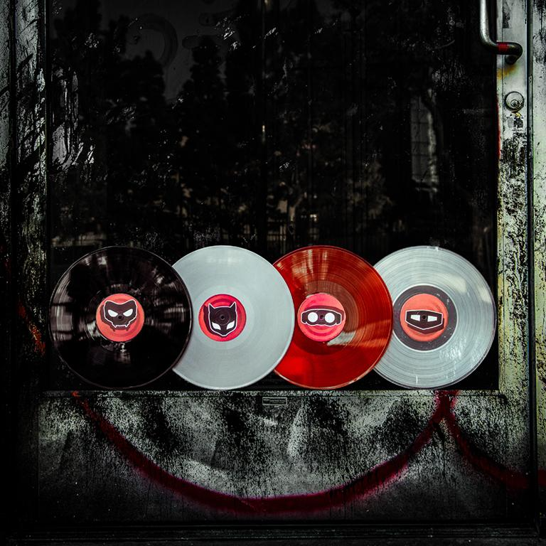 the black, grey, red, and clear Persona 5 vinyl discs set up in an abandoned window for a product shot.
