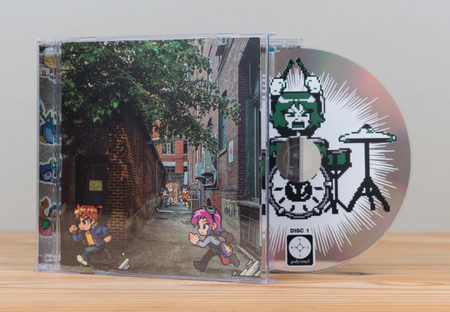 A CD case and disc for Scott Pilgrim EX displayed on a light wooden surface against a neutral gray background. The CD cover features pixel art of two cartoon characters against a real photo of an alleyway and the CD disc is decorated with a pixel art drummer character.