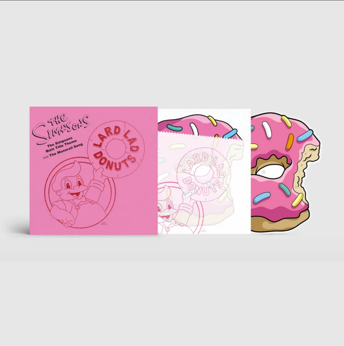 A shot of the Simpsons 10" record set showing the all pink front cover with an illustration of Lard Lad, the insertof the same illustration but made to look like a donut in a wrapper, and the 10" disc poking out that is a pink sprinkle donut diecut shape.