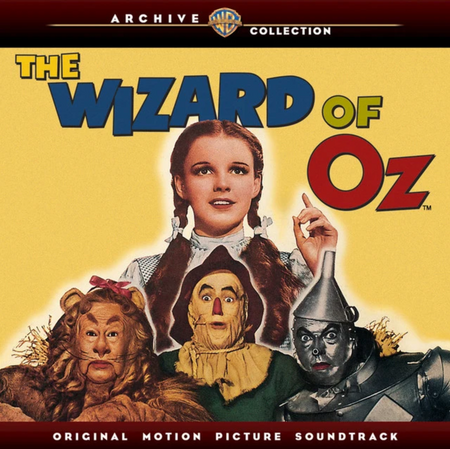 The Wizard of Oz Original Motion Picture Soundtrack vinyl album cover from the Warner Archive Collection, featuring Judy Garland, the Scarecrow, Tin Man, Cowardly Lion, and Wizard on a yellow background.