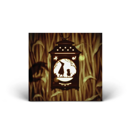 The CD front cover is the same as the vinyl. A lit lantern hangs in front of a corn field and the silhouette of two characters is in the center of the lantern. There is a shadow of a monster's hand projected onto the corn field wall.