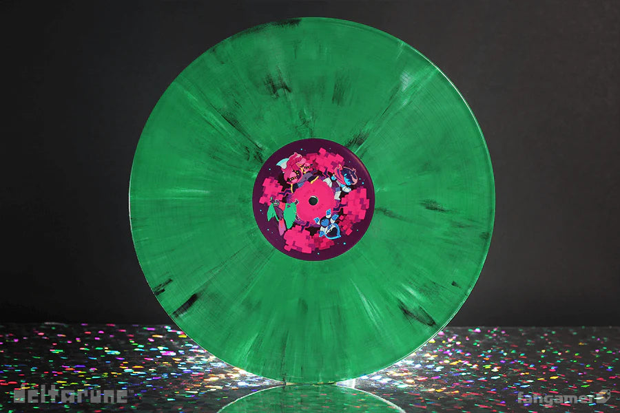 Green vinyl record with a colorful label on a reflective surface