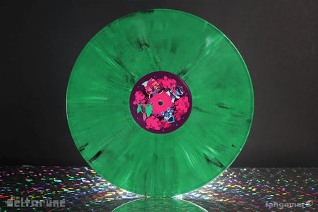 Green vinyl record with a colorful label on a reflective surface