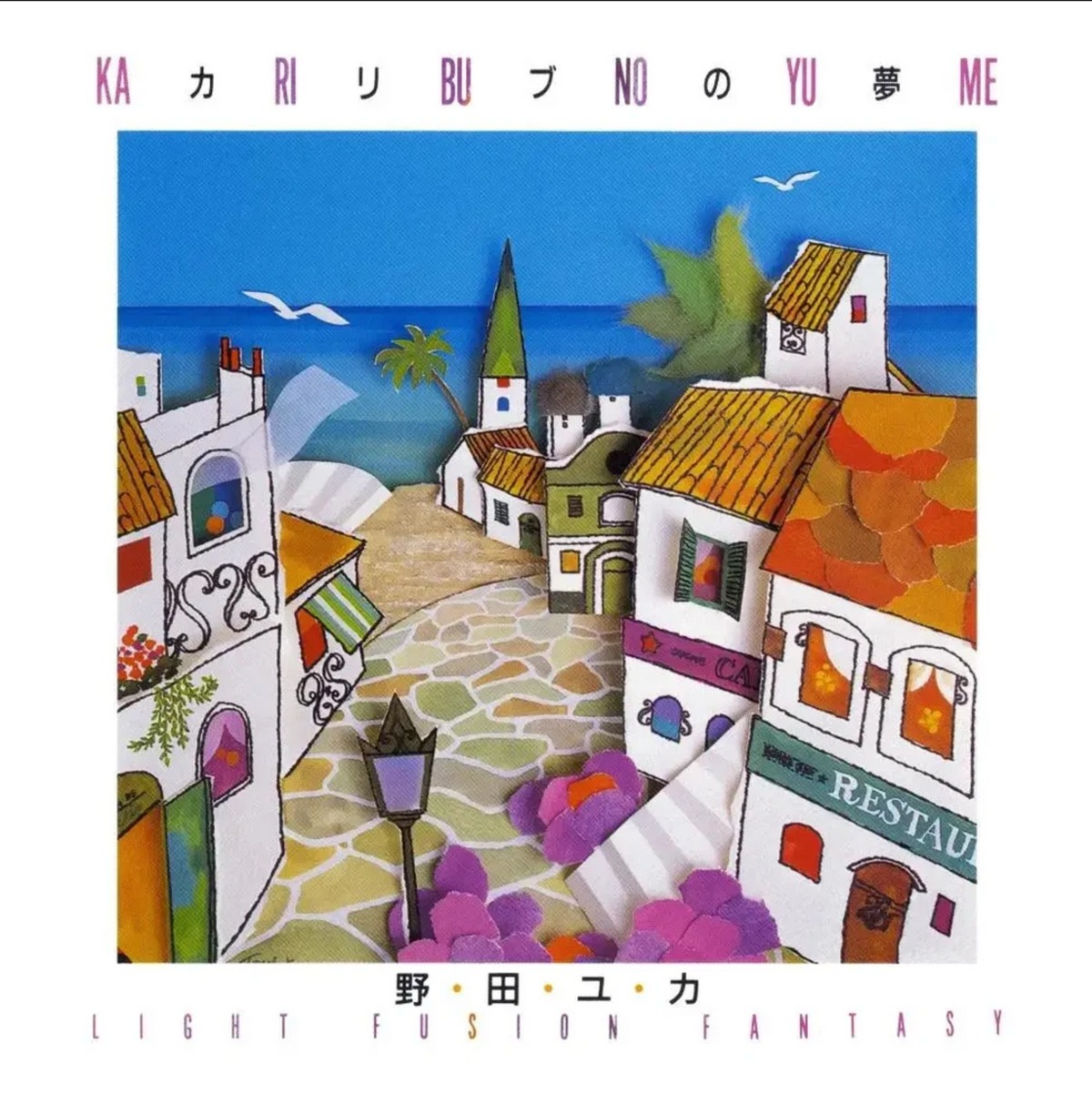 Japanese album cover for 'Ka Ri Bu No Yu Me' , featuring a colorful hand-drawn illustration of a coastal village with white houses, orange roofs, a blue sea, and a stone pathway.